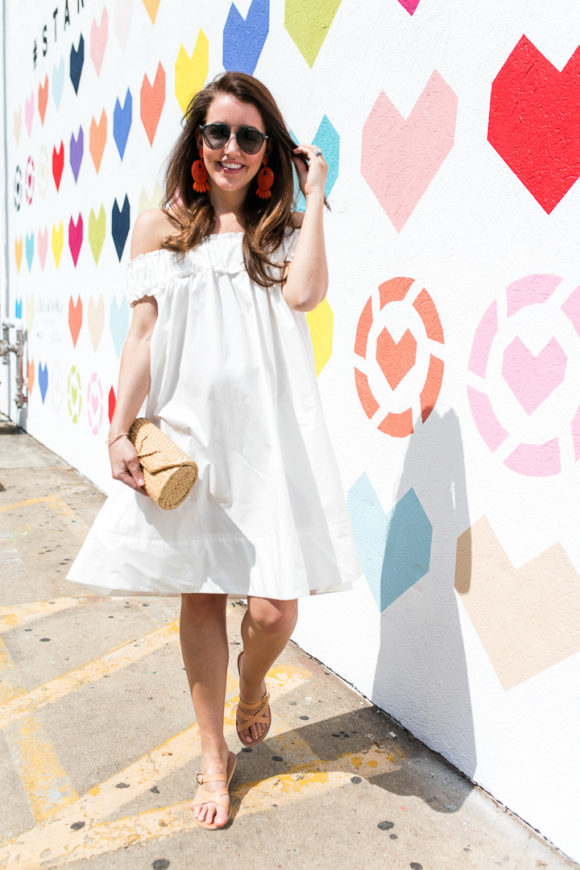 Amy Havins wears a white off the shoulder dress.