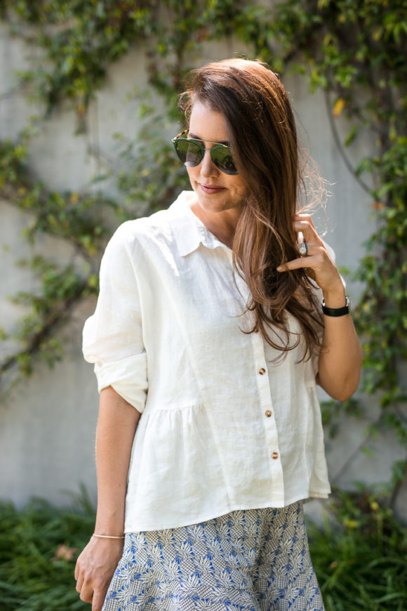 Amy Havins wears ruffle shorts and a white linen blouse.