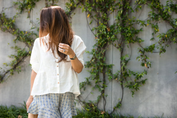 Amy Havins wears ruffle shorts and a white linen blouse.