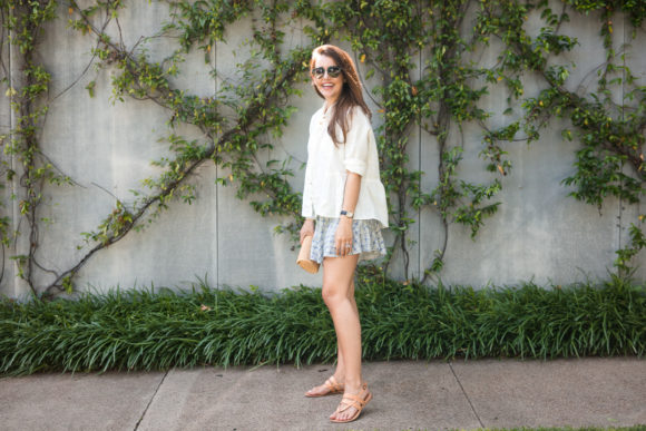 Amy Havins wears ruffle shorts and a white linen blouse.