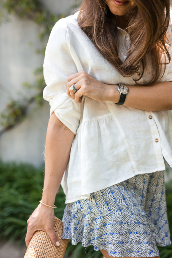 Amy Havins wears ruffle shorts and a white linen blouse.