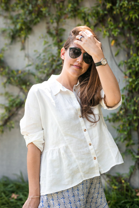 Amy Havins wears ruffle shorts and a white linen blouse.