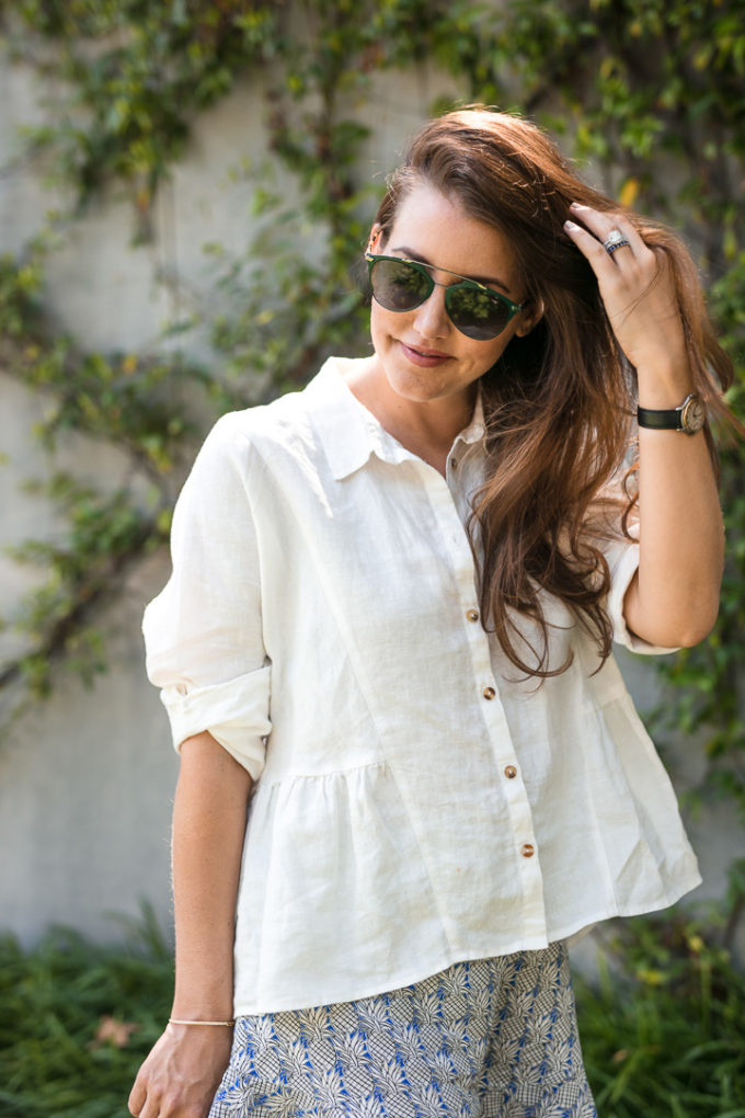 Amy Havins wears ruffle shorts and a white linen blouse.