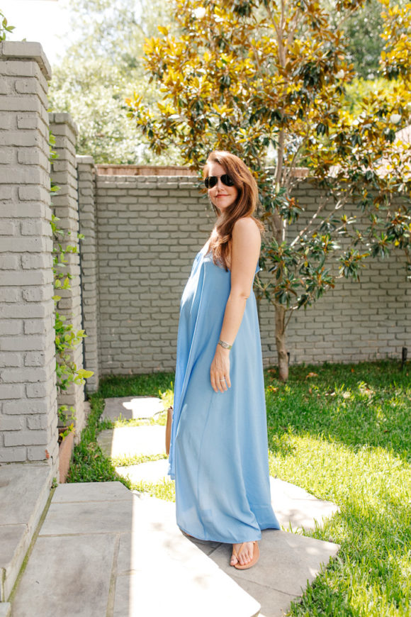 Amy Havins wears a blue maxi dress and neutral flats.
