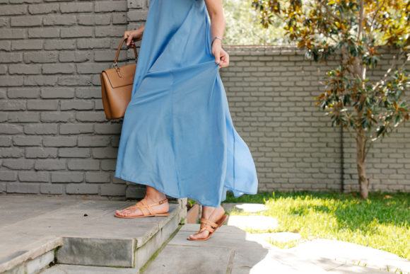 Amy Havins wears a blue maxi dress and neutral flats.