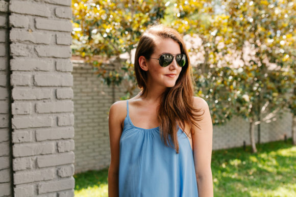 Amy Havins wears a blue maxi dress and neutral flats.