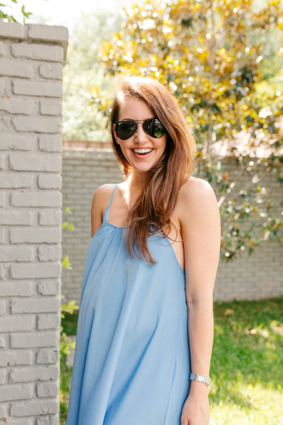 Amy Havins wears a blue maxi dress and neutral flats.