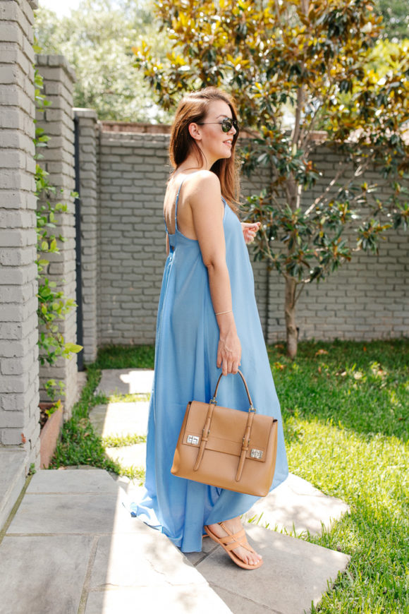 Amy Havins wears a blue maxi dress and neutral flats.