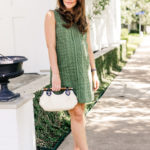 Amy Havins wears a green shift dress.