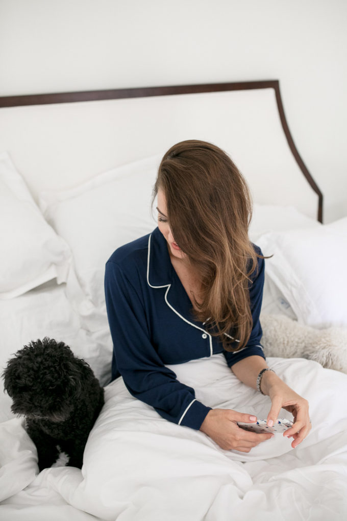 Amy Havins wears navy pajamas and shares a bump date.