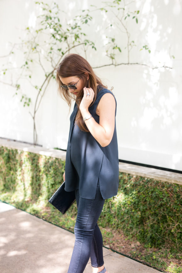 Amy havins wears a navy tunic, jeans and jimmy choo sandals.