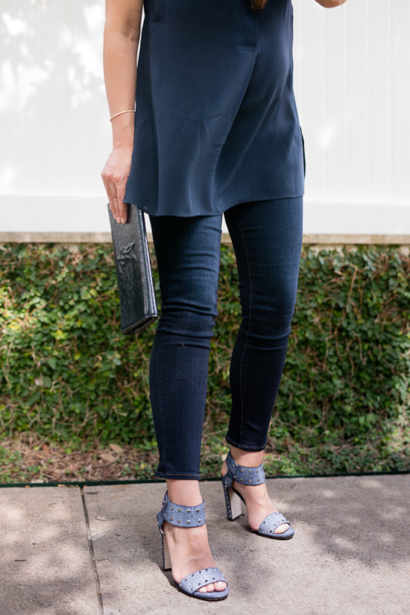 Amy havins wears a navy tunic, jeans and jimmy choo sandals.