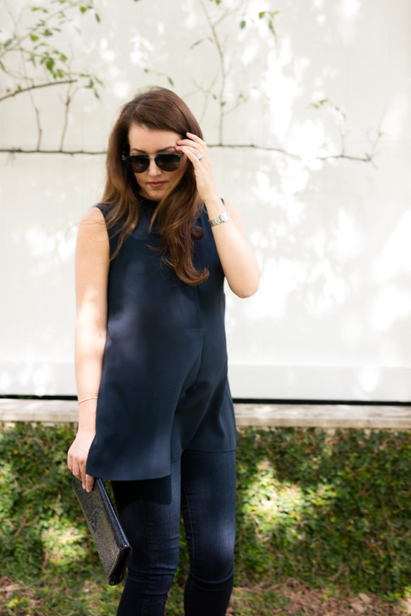 Amy havins wears a navy tunic, jeans and jimmy choo sandals.