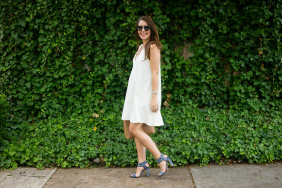 Amy Havins wears a white summer dress with blue jimmy choo heels.