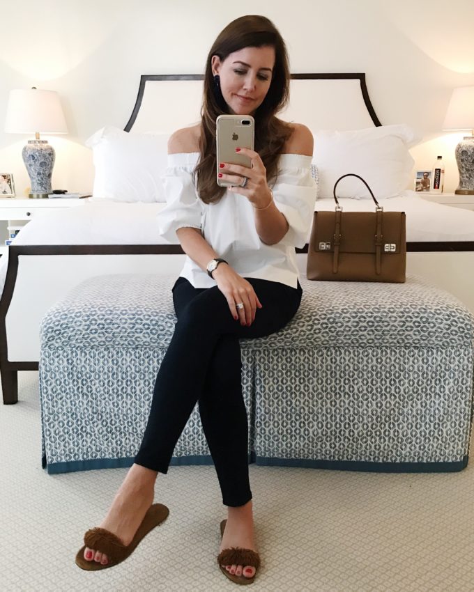 Amy havins wears jeans and a white blouse.