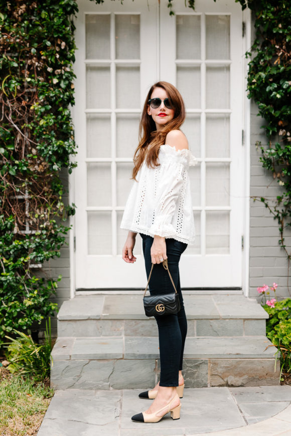 Amy Havins wears jeans and white off the shoulder blouse.