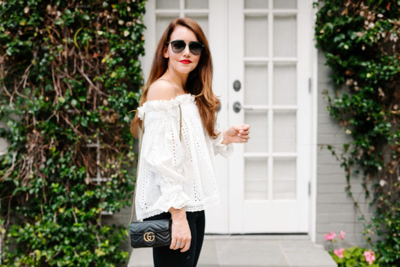 Amy Havins wears jeans and white off the shoulder blouse.