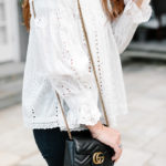 Amy Havins wears jeans and white off the shoulder blouse.