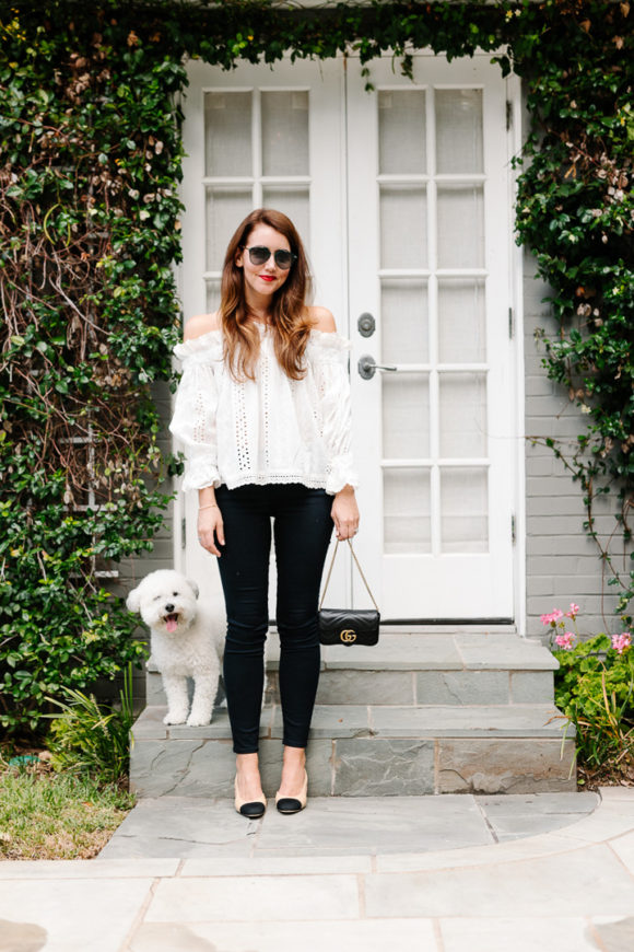 Amy Havins wears jeans and white off the shoulder blouse.