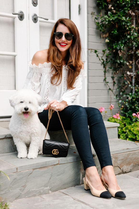 Amy Havins wears jeans and white off the shoulder blouse.