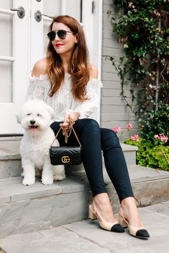 Amy Havins wears jeans and white off the shoulder blouse.