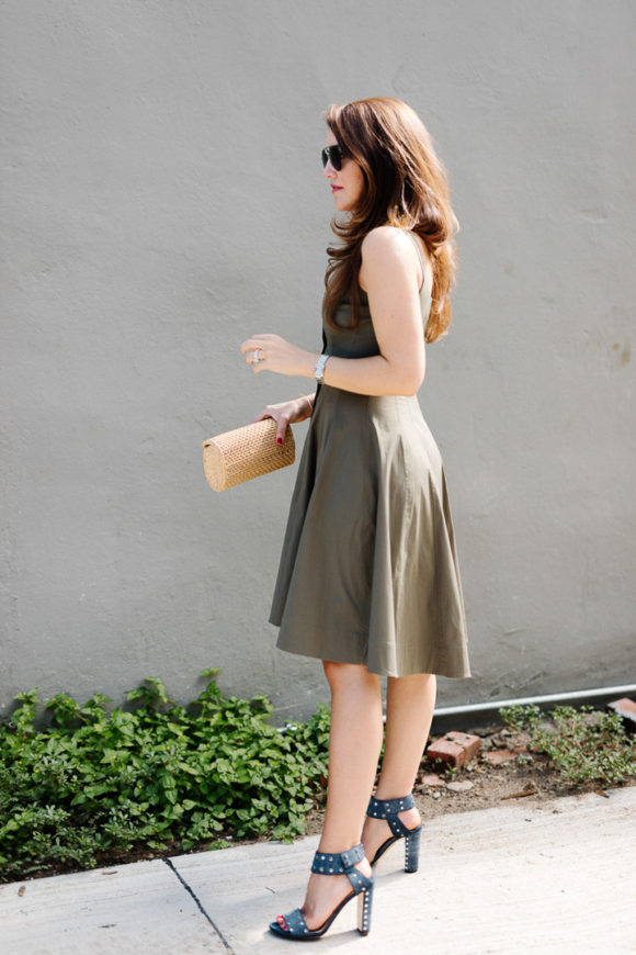 Amy havins wears a green fit & flare dress.