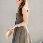 Amy havins wears a green fit & flare dress.