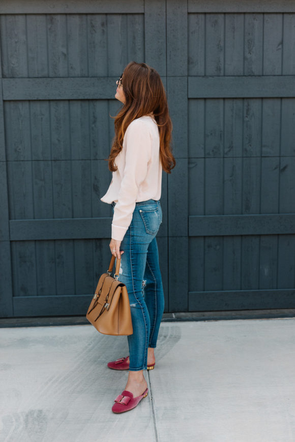 Amy Havins wears a blush blouse, ripped jeans and velvet flats.