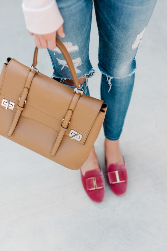 Amy Havins wears a blush blouse, ripped jeans and velvet flats.