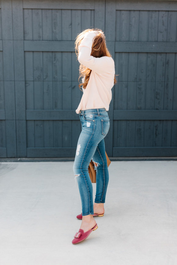 Amy Havins wears a blush blouse, ripped jeans and velvet flats.