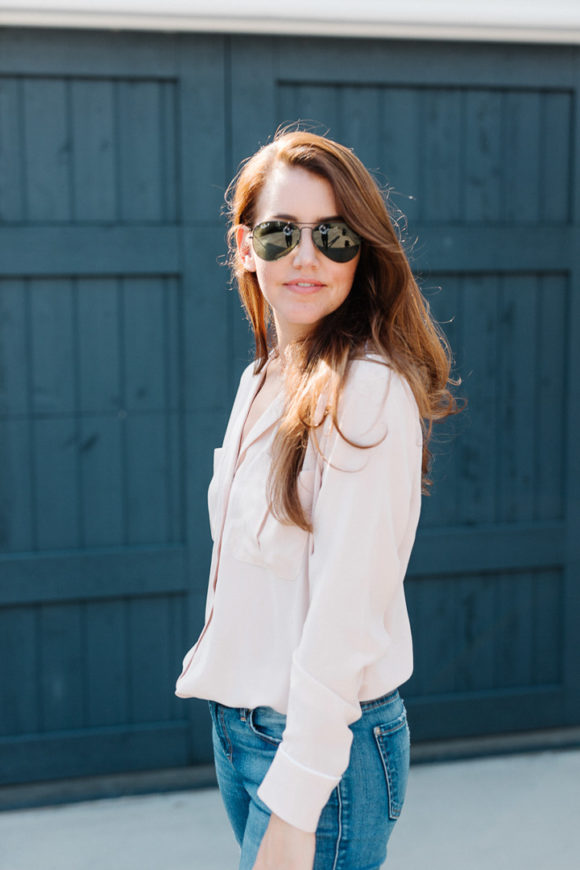 Amy Havins wears a blush blouse, ripped jeans and velvet flats.