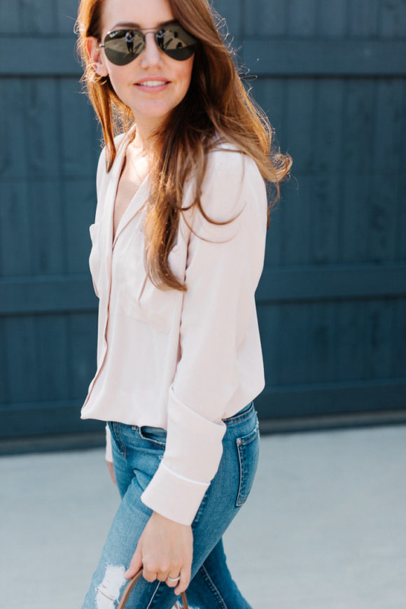 Amy Havins wears a blush blouse, ripped jeans and velvet flats.