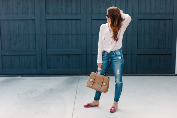 Amy Havins wears a blush blouse, ripped jeans and velvet flats.