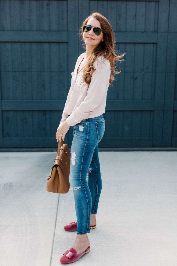 Amy Havins wears a blush blouse, ripped jeans and velvet flats.