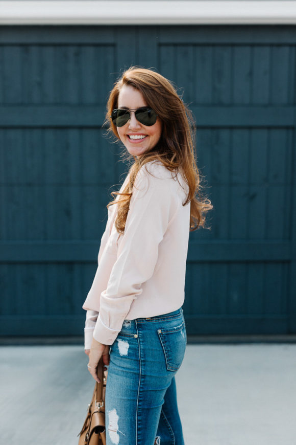 Amy Havins wears a blush blouse, ripped jeans and velvet flats.