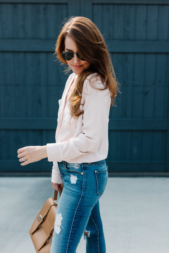 Amy Havins wears a blush blouse, ripped jeans and velvet flats.