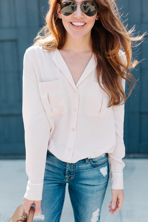 Amy Havins wears a blush blouse, ripped jeans and velvet flats.