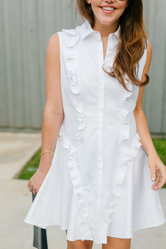 Amy Havins wears a white ruffle dress and jimmy choo shoes.