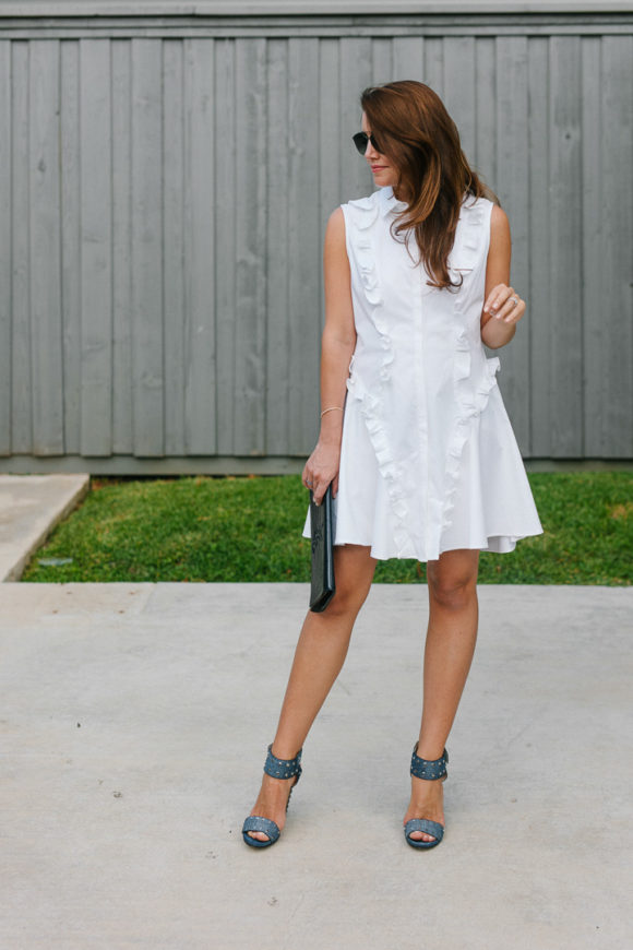 Amy Havins wears a white ruffle dress and jimmy choo shoes.