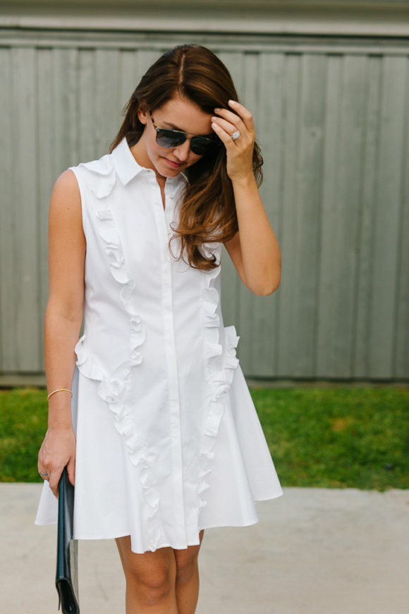 Amy Havins wears a white ruffle dress and jimmy choo shoes.