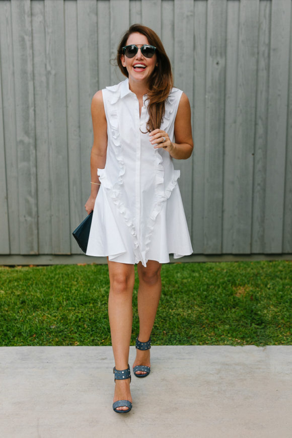 Amy Havins wears a white ruffle dress and jimmy choo shoes.