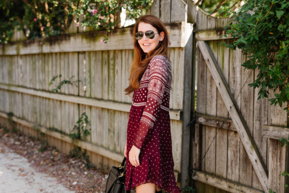 Amy Havins wears a merlot shoshanna dress and black over the knee boots.