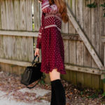 Amy Havins wears a merlot shoshanna dress and black over the knee boots.