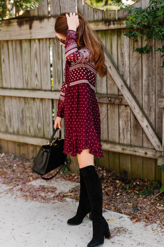 Amy Havins wears a merlot shoshanna dress and black over the knee boots.