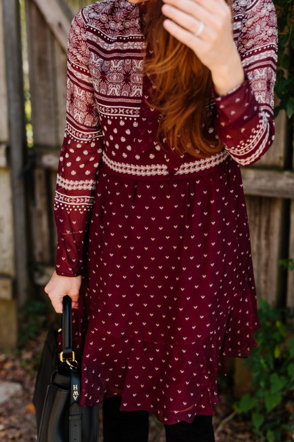 Amy Havins wears a merlot shoshanna dress and black over the knee boots.