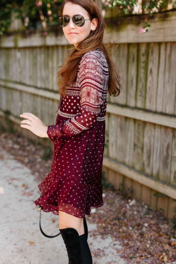 Amy Havins wears a merlot shoshanna dress and black over the knee boots.