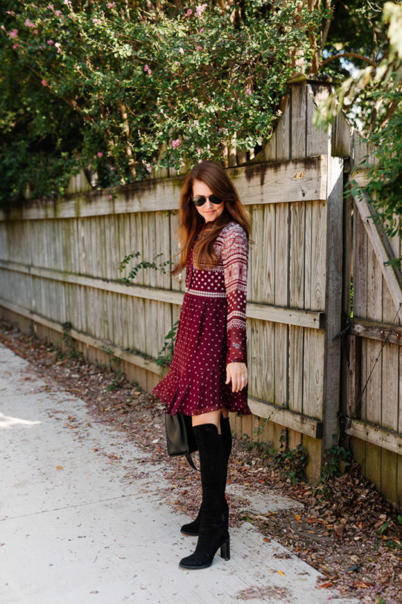 Amy Havins wears a merlot shoshanna dress and black over the knee boots.