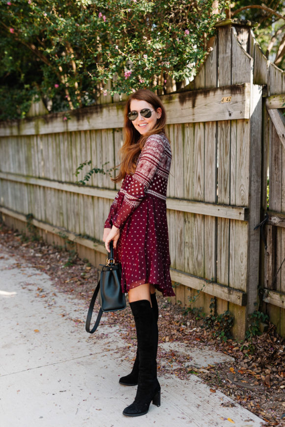 Amy Havins wears a merlot shoshanna dress and black over the knee boots.