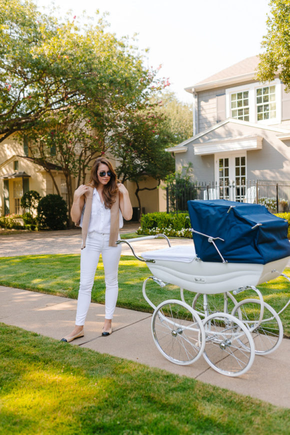 Amy Havins wears white denim and pushes Ralph in her silver cross stroller.