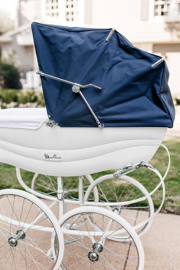 Amy Havins wears white denim and pushes Ralph in her silver cross stroller.